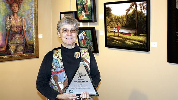 Linda Bunch, executive director of the Suffolk Art League, shows off her Alli, the award she won from the Cultural Alliance of Greater Hampton Roads for her contributions to the arts in Suffolk and throughout Hampton Roads.